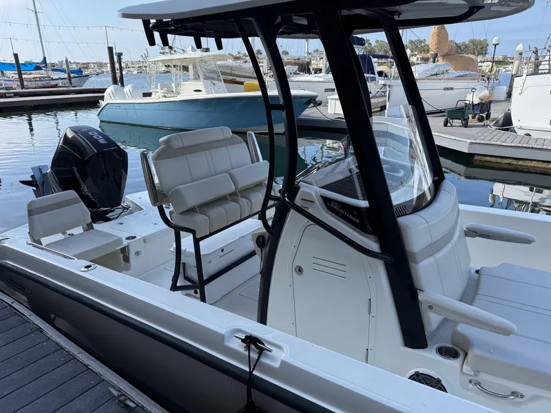 Slide: The Image of 2024 Boston Whaler 250 Dauntless boat docked at marina, featuring sleek design and modern seating. - 1