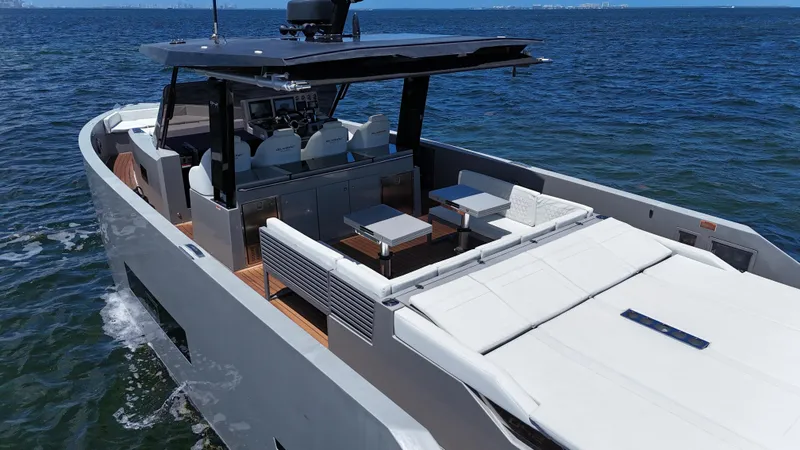 Slide: The Image of Luxury 2021 De Antonio Yachts D42 cruising on open water, featuring sleek design and spacious deck. - 13
