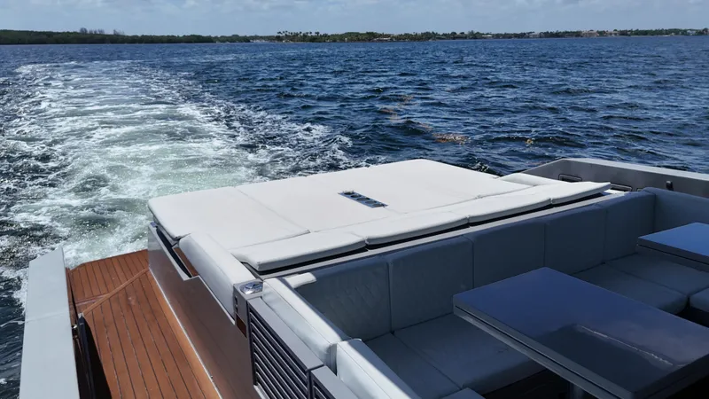 Slide: The Image of 2021 De Antonio Yachts D42 cruising on open water, featuring spacious deck seating. - 15