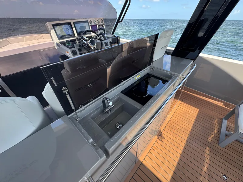 Slide: The Image of 2021 De Antonio Yachts D42 helm with modern controls and sleek design on open water. - 20