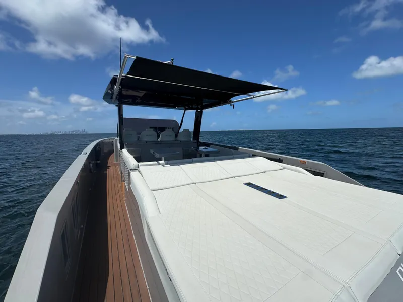 Slide: The Image of De Antonio Yachts D42 2021 on open water, featuring sleek design and spacious deck. - 22