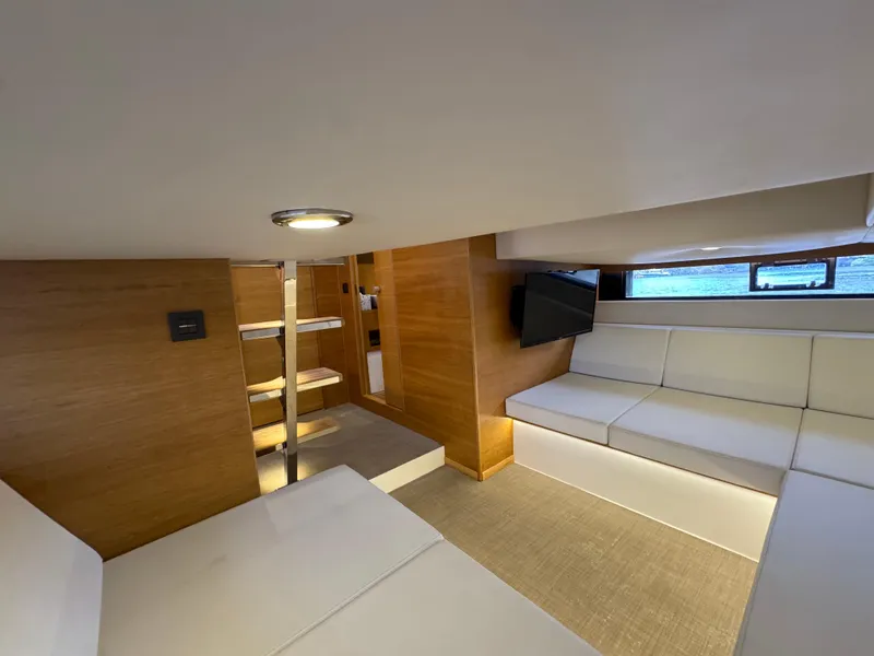 Slide: The Image of Interior of 2021 De Antonio Yachts D42, featuring modern seating and wooden accents. - 32