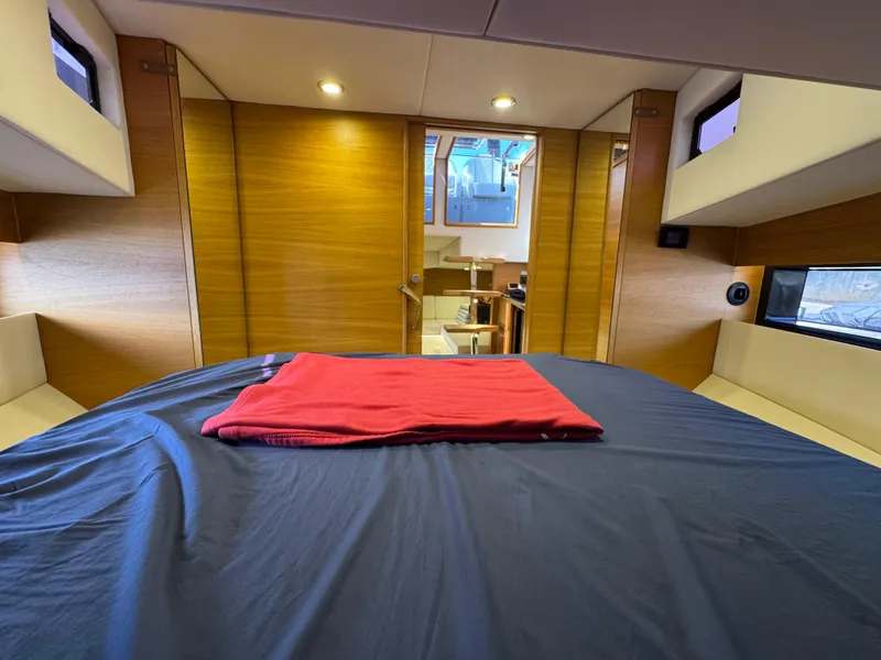 Slide: The Image of Interior cabin of 2021 De Antonio Yachts D42 with modern wood finish and cozy bedding. - 36