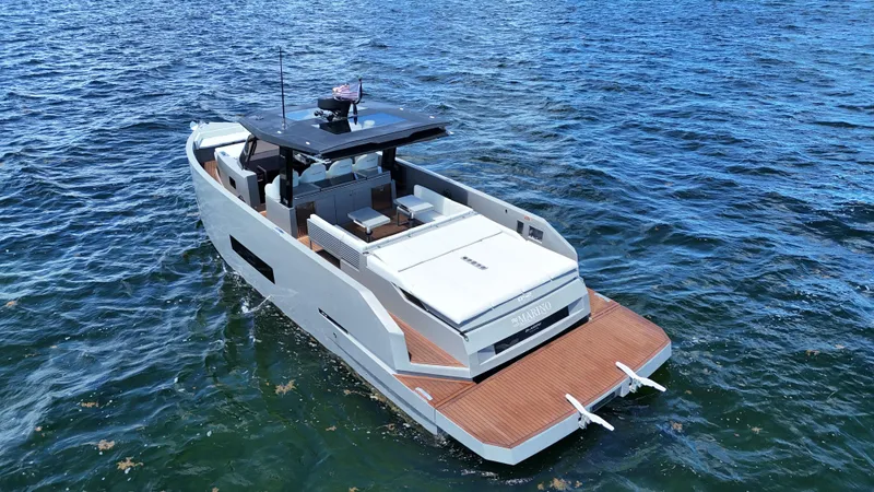 Slide: The Image of 2021 De Antonio Yachts D42 on open water, showcasing sleek design and spacious deck. - 9