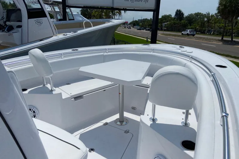 Slide: The Image of 2026 Sportsman Heritage 231 Center Console boat interior with seating and table. - 21