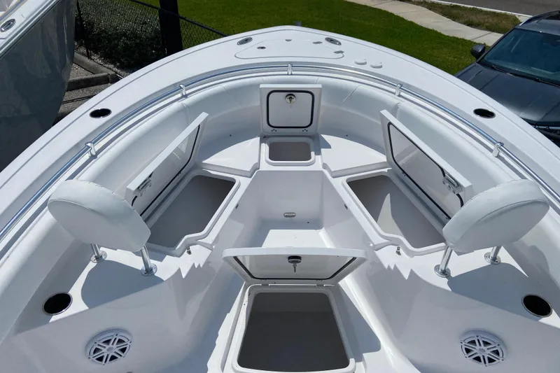 Slide: The Image of 2026 Sportsman Heritage 231 Center Console boat with open storage compartments and seating. - 22
