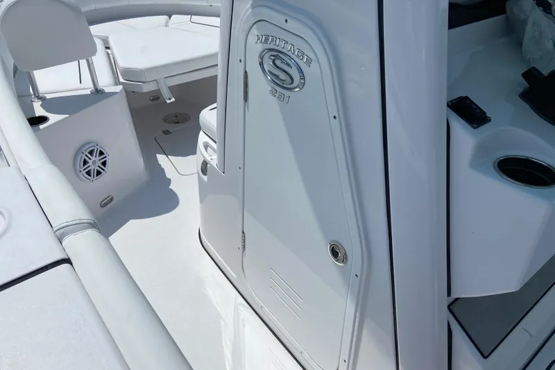 Slide: The Image of 2026 Sportsman Heritage 231 Center Console boat interior, featuring seating and storage areas. - 24