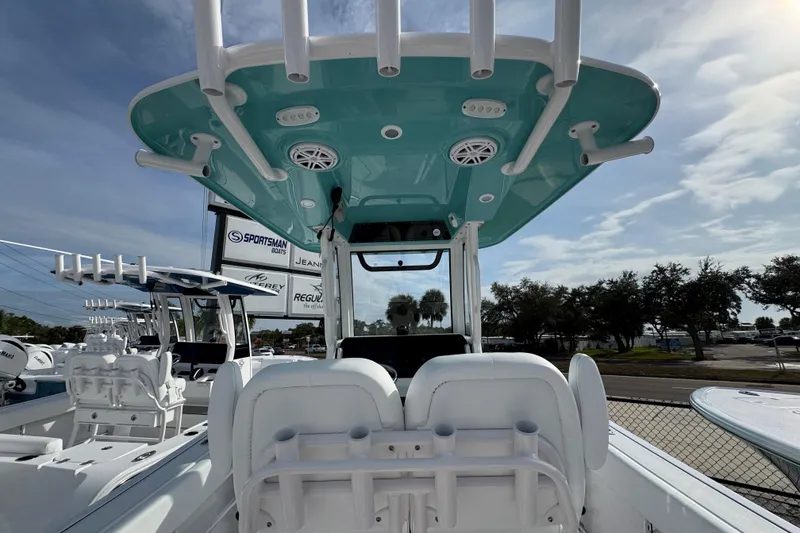 Slide: The Image of 2026 Sportsman Heritage 231 Center Console boat with teal canopy and rod holders. - 9