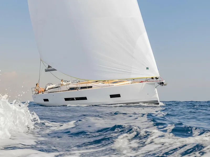 Slide: The Image of 2023 Hanse 460 sailboat navigating ocean waves under clear blue sky. - 0