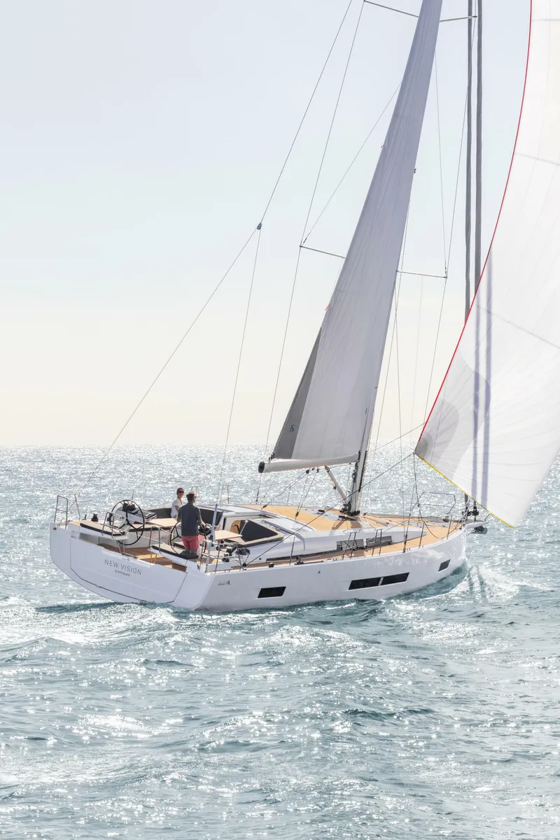 Slide: The Image of 2023 Hanse 460 sailboat navigating on open water under clear skies. - 1