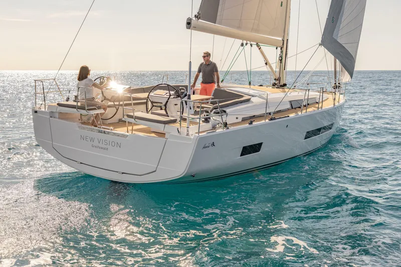 Slide: The Image of 2023 Hanse 460 sailboat cruising on open sea with two people on deck. - 6