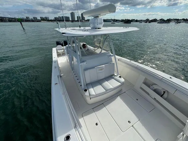 Slide: The Image of 2015 Invincible 39 Open Fisherman boat on water, spacious deck, city skyline in background. - 19