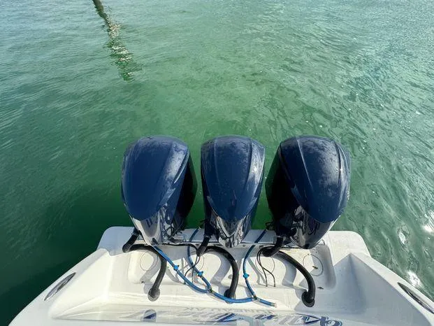 Slide: The Image of 2015 Invincible 39 Open Fisherman with triple outboard motors on clear water. - 24