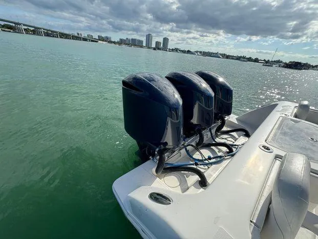 Slide: The Image of 2015 Invincible 39 Open Fisherman boat with triple outboard engines on calm water. - 25