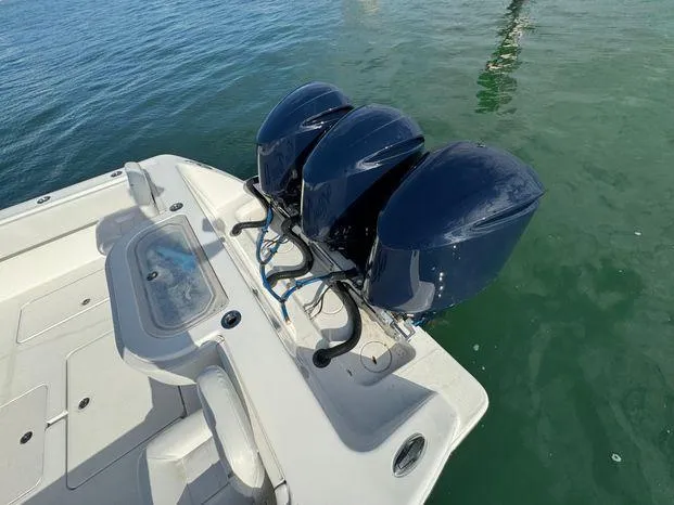 Slide: The Image of 2015 Invincible 39 Open Fisherman with triple outboard motors on calm water. - 26