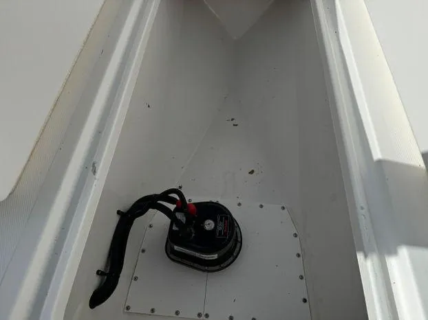 Slide: The Image of 2015 Invincible 39 Open Fisherman storage compartment with a black pump. - 31