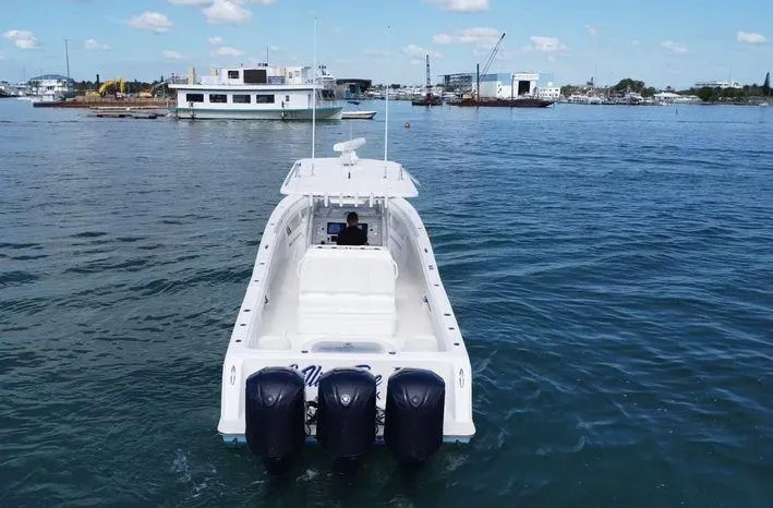 Slide: The Image of 2015 Invincible 39 Open Fisherman boat with four engines on calm water. - 5