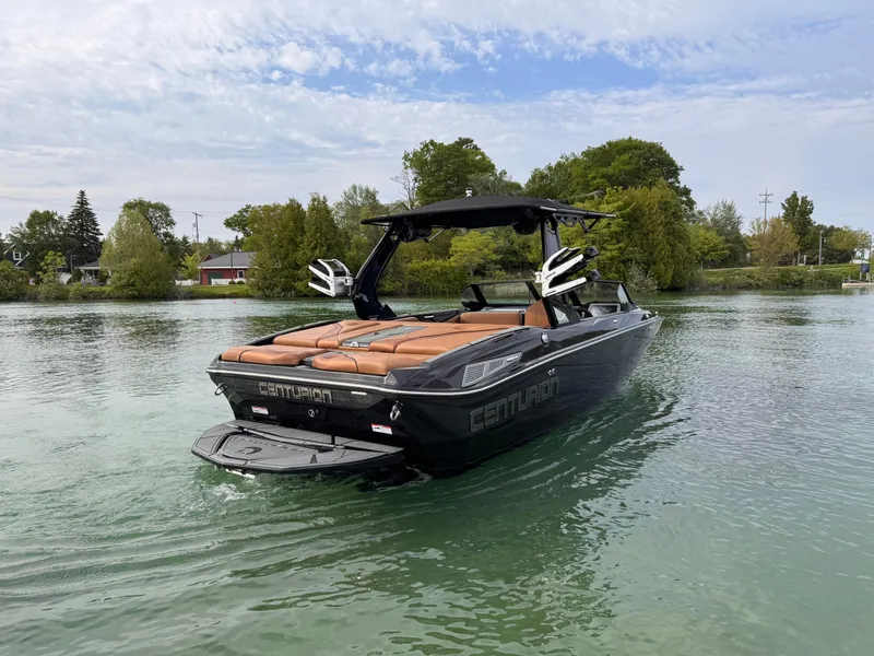 Slide: The Image of 2025 Centurion NV 213 boat on a serene lake with lush greenery. - 4