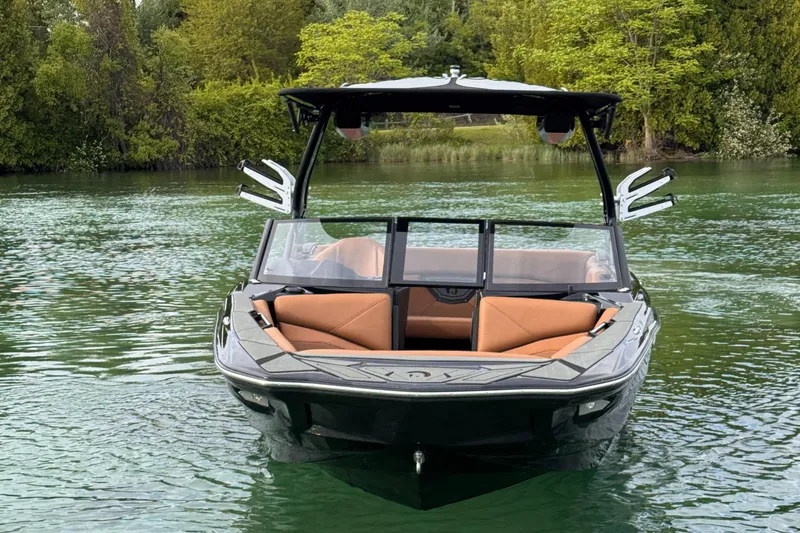 Slide: The Image of 2025 Centurion NV 213 boat on a serene lake with lush greenery. - 7