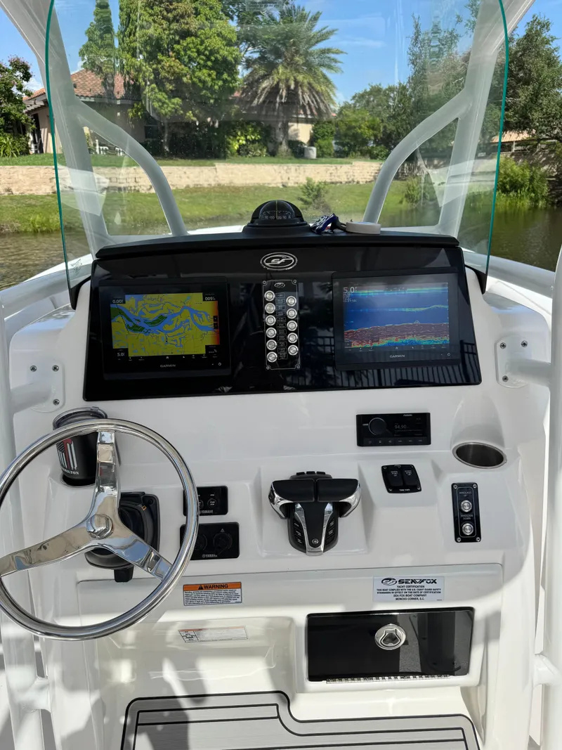 Slide: The Image of 2023 Sea Fox 268 Commander dashboard with navigation screens and steering wheel. - 12
