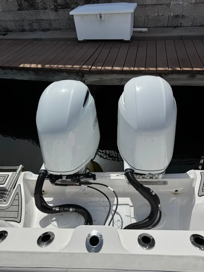 Slide: The Image of Twin outboard engines on a 2023 Sea Fox 268 Commander boat at a dock. - 18