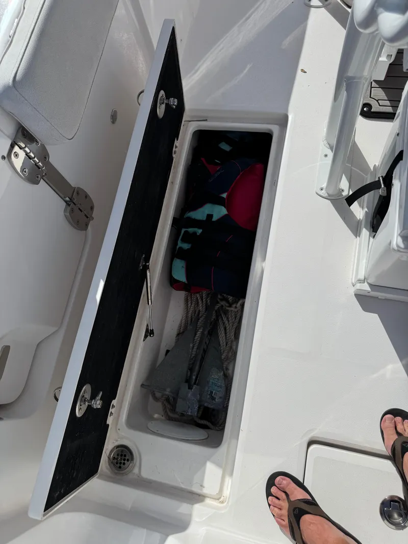 Slide: The Image of Open storage compartment on 2023 Sea Fox 268 Commander boat, containing life jackets and ropes. - 19