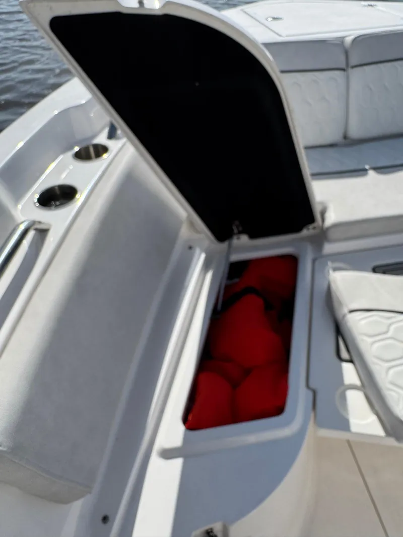 Slide: The Image of 2023 Sea Fox 268 Commander boat storage compartment with red life jackets. - 23
