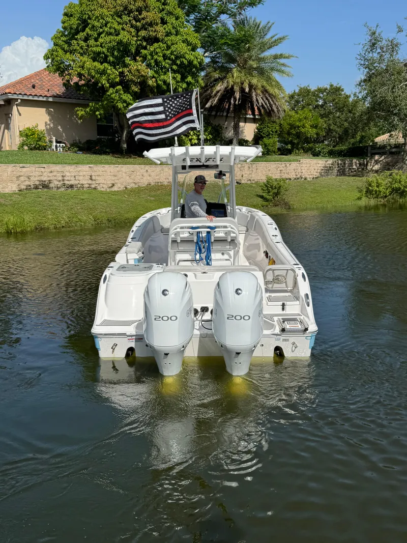 Slide: The Image of 2023 Sea Fox 268 Commander boat with dual engines on a calm waterway. - 3