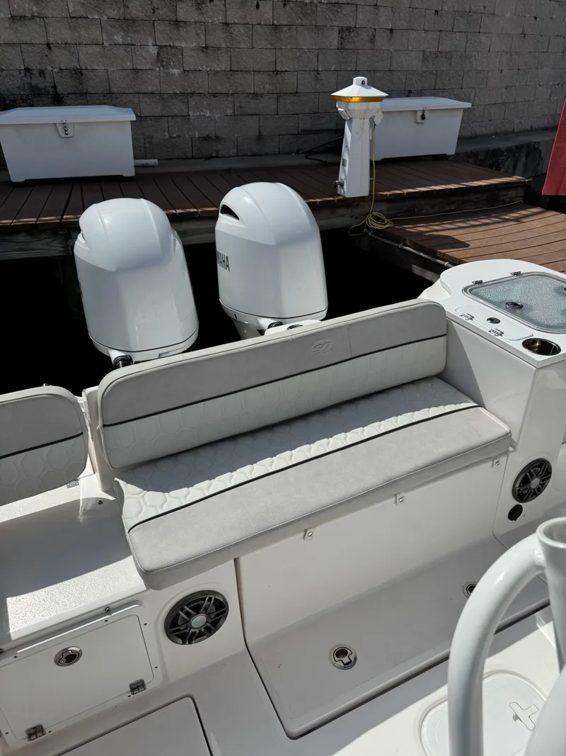 Slide: The Image of 2023 Sea Fox 268 Commander boat with Yamaha engines, docked, featuring cushioned seating. - 7