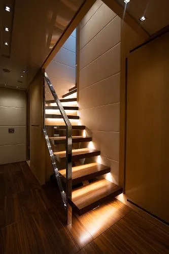Slide: The Image of Luxurious interior staircase on 2017 Sanlorenzo SL106 yacht, featuring elegant lighting and wooden finishes. - 16