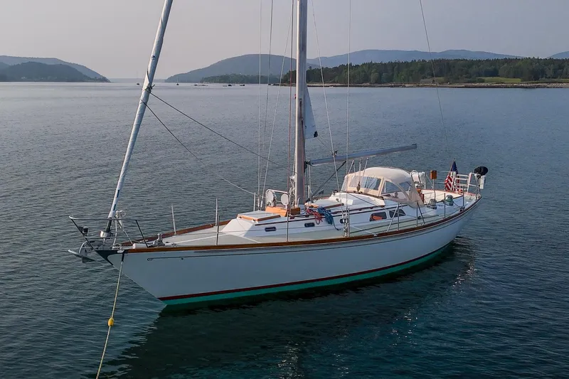 Slide: The Image of 1988 Hinckley Sou'wester 42 sailboat anchored in scenic coastal waters. - 1