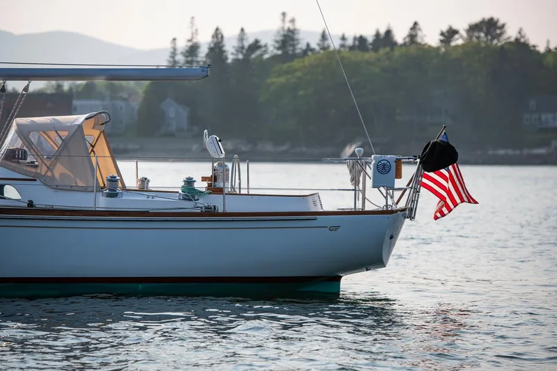 Slide: The Image of 1988 Hinckley Sou'wester 42 sailboat on calm water, American flag waving. - 17