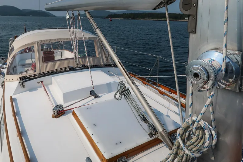 Slide: The Image of 1988 Hinckley Sou'wester 42 sailboat deck with rigging, sailing on calm waters. - 26