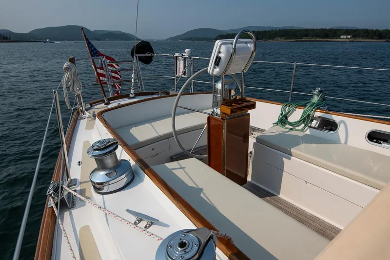 Slide: The Image of 1988 Hinckley Sou'wester 42 sailboat cockpit with American flag, scenic water view. - 28