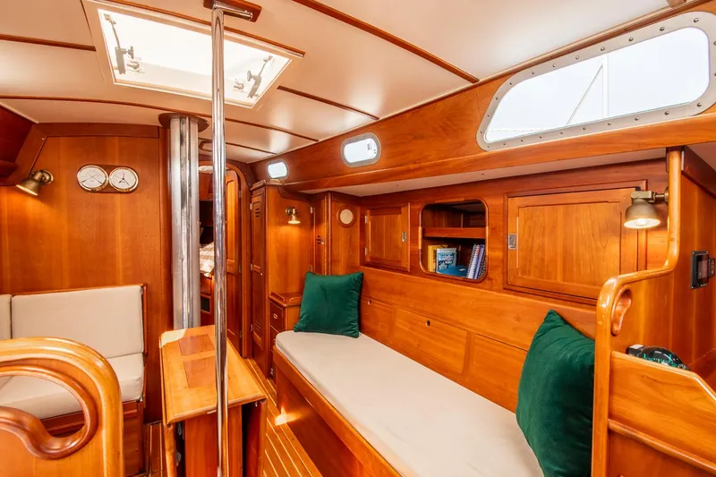 Slide: The Image of Interior of 1988 Hinckley Sou'wester 42 sailboat with wooden furnishings and cozy seating. - 38