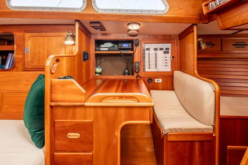 Slide: The Image of Hinckley Sou'wester 42 yacht interior, 1988 model, featuring a wooden navigation station and seating area. - 39