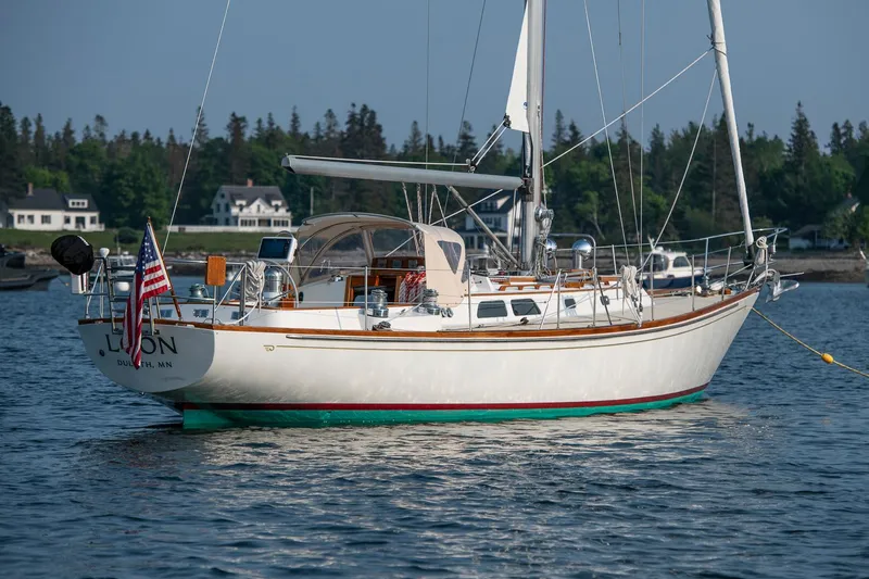 Slide: The Image of 1988 Hinckley Sou'wester 42 sailboat anchored in scenic coastal waters. - 4