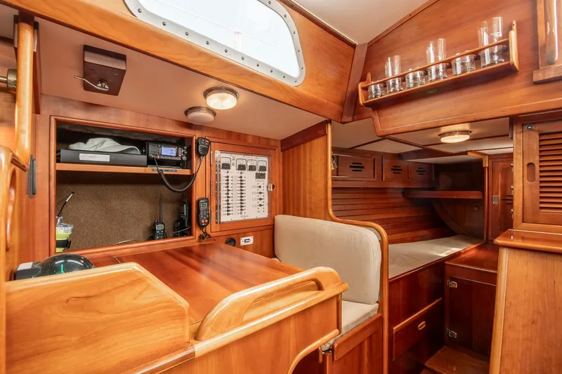 Slide: The Image of 1988 Hinckley Sou'wester 42 yacht interior with navigation station and cozy wooden cabin. - 40