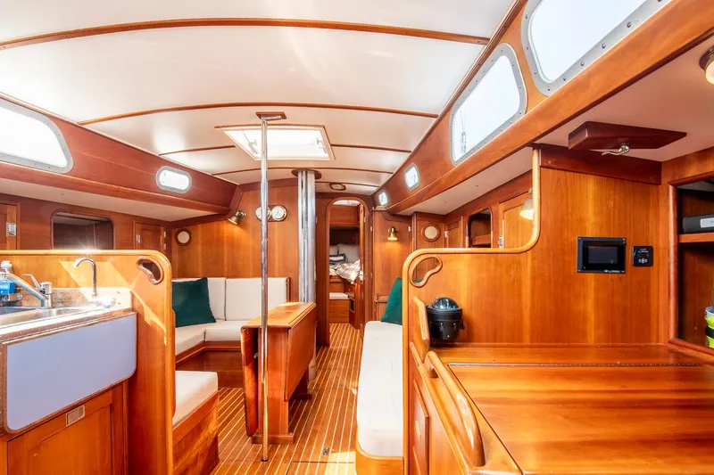 Slide: The Image of Interior of 1988 Hinckley Sou'wester 42 sailboat, featuring elegant woodwork and spacious layout. - 42