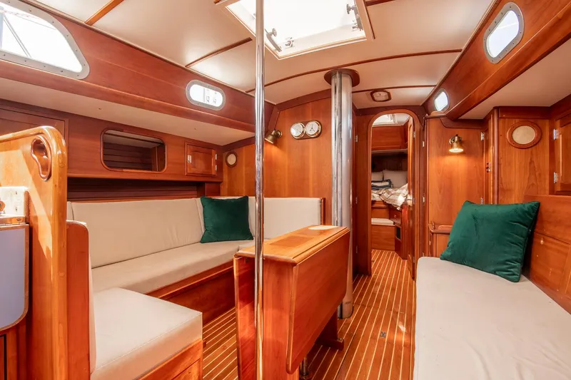 Slide: The Image of Interior of 1988 Hinckley Sou'wester 42 sailboat with wooden furnishings and cozy seating. - 46