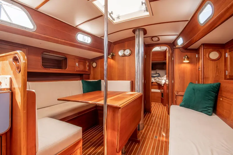 Slide: The Image of Interior of 1988 Hinckley Sou'wester 42 sailboat with wooden furnishings and cozy seating. - 47