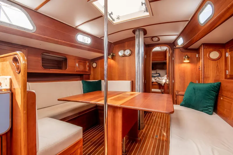 Slide: The Image of Interior of 1988 Hinckley Sou'wester 42 sailboat with wooden furnishings and cozy seating area. - 48