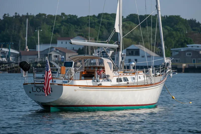 Slide: The Image of Hinckley Sou'wester 42 sailboat from 1988 on calm water, with American flag. - 5