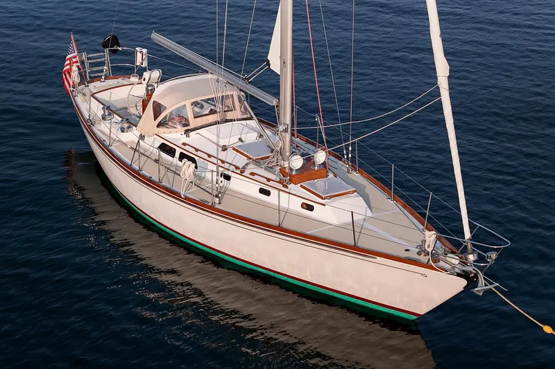 Slide: The Image of 1988 Hinckley Sou'wester 42 sailboat on calm water, showcasing elegant design and craftsmanship. - 8