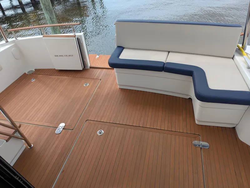 Slide: The Image of 2019 Beneteau Swift Trawler 44 deck with seating and wooden flooring. - 10