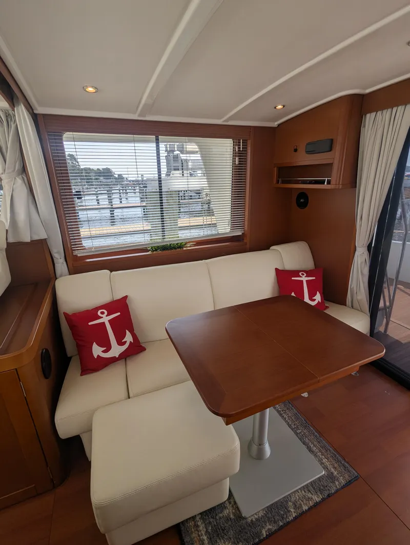 Slide: The Image of Interior of 2019 Beneteau Swift Trawler 44 with cozy seating and nautical decor. - 17