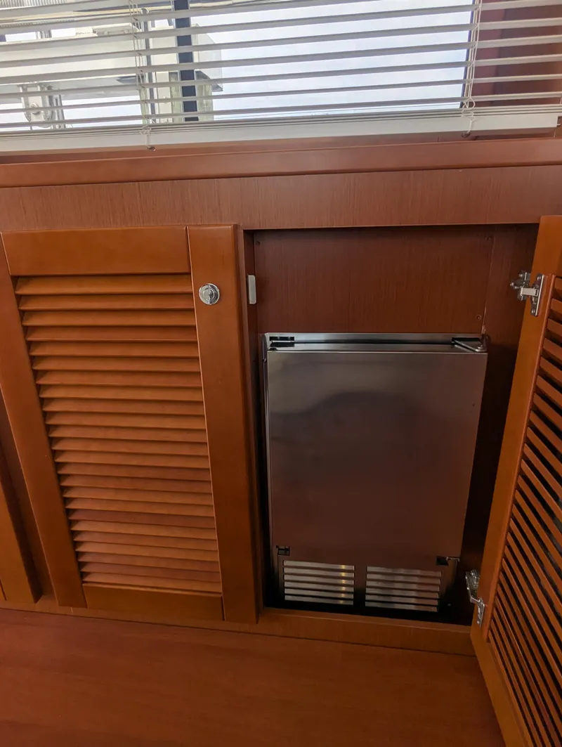 Slide: The Image of Wooden cabinet with stainless steel appliance on Beneteau Swift Trawler 44, 2019 model. - 22