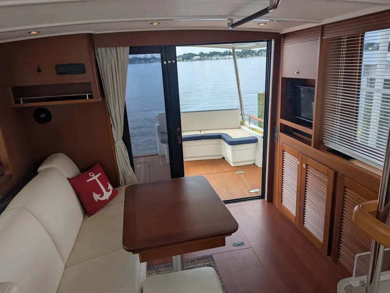 Slide: The Image of Interior of 2019 Beneteau Swift Trawler 44 with elegant seating and scenic water view. - 28