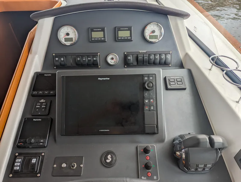 Slide: The Image of Control panel of a 2019 Beneteau Swift Trawler 44 with navigation and engine controls. - 30