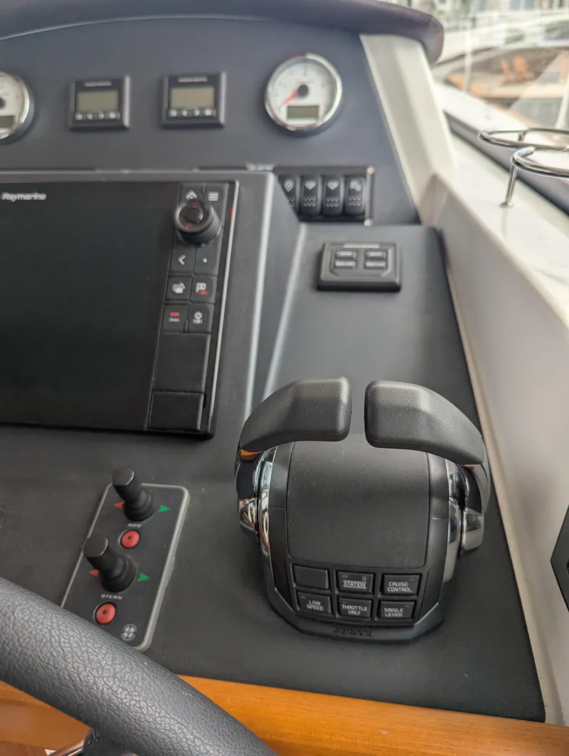 Slide: The Image of Control panel of 2019 Beneteau Swift Trawler 44 with navigation and throttle controls. - 33